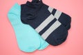 Two pairs of sports socks on a pink background top view.