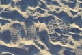 Two pairs of steps in a sand. Love trails. Togetherness. Royalty Free Stock Photo