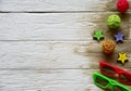 Two pairs of sunglasses, multi-colored rattan balls, multi-colored wooden stars and sand on a white wooden background. Royalty Free Stock Photo