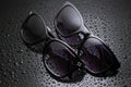 two pairs sunglasses with water drops Royalty Free Stock Photo