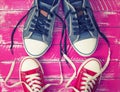 Two pairs of textile sneakers with loose laces Royalty Free Stock Photo