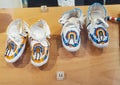 Two Pairs of White Leather Children`s Moccasins with Beadwork