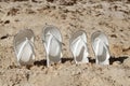 Pairs of white sandals in the sand at the beach Royalty Free Stock Photo