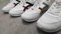 Two pairs of white sneakers on a cement floor Royalty Free Stock Photo