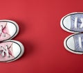 two pairs of worn classic textile pairs of shoes on a red background