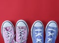 Two pairs of worn textile sneakers with white laces