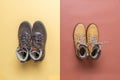 Two pairs of yellow and brown men`s and women`s winter suede leather stylish boots on color background. Casual trendy footwear, Royalty Free Stock Photo