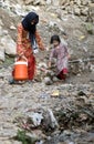 Two Pakistani children bringing water