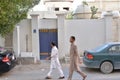 Two Pakistani men walking in the street of a popular district of Doha