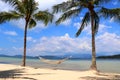 Two palm trees with a hammock on the beach - Gaya Island Malaysia Asia Royalty Free Stock Photo