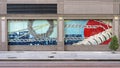 Two panels of a five panel tile mural on the outside of a building on Bryan Street in downtown Dallas, Texas.