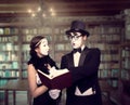 Two pantomime theater performers posing with book