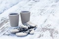 paper craft glass, cup with a hot drink, coffee, cocoa, mulled wine and white and black mittens