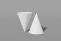 Two paper cups mockup cone shaped on a grey background. One of the cups is turned upside down. 3D rendering Royalty Free Stock Photo