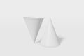 Two paper cups mockup cone shaped on a white background. One of the cups is turned upside down. 3D rendering Royalty Free Stock Photo