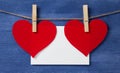 Two paper hearts and card hanging on a rope Royalty Free Stock Photo