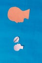 Two Paper Human face with what Question Mark on speech bubble isolated on blue background. Conceptual images showing Big Questions Royalty Free Stock Photo