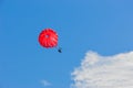 Two people under red parachute flying over the blue sky Royalty Free Stock Photo