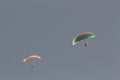 Two paragliders in blue sky