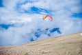 Two paragliders flying in the clouds near lake Garda