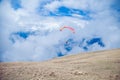 Two paragliders flying in the clouds near lake Garda