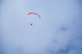 Two paragliders flying in the clouds near lake Garda