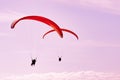 Two paragliders in pink sunset