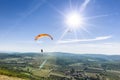 Two paragliders under the rays of a white sun Royalty Free Stock Photo