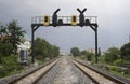 Two parallel railway pass in a city with a railway traffic light