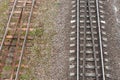 Two parallel railway tracks. top view. On left is old rusty road with wooden sleepers. On right is new shiny one with reinforced Royalty Free Stock Photo