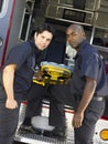 Two paramedics removing gurney from ambulance Royalty Free Stock Photo