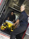 Two paramedics removing gurney from ambulance Royalty Free Stock Photo