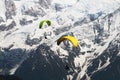 Two Parapenters flying over french snowy Mont Blanc massif Royalty Free Stock Photo