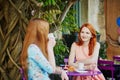 Two Parisian women drinking coffee together in cafe