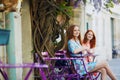 Two Parisian women drinking coffee together in cafe