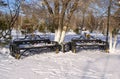 Two park benches are covered by fresh snow. Winter snow park benches view during day light Royalty Free Stock Photo