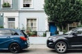 Two parked cars in front of an apartment entrance Royalty Free Stock Photo