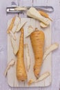 Two parsnips on wooden board Royalty Free Stock Photo