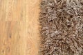 Two part split image of brown shaggy carpet and wooden floor