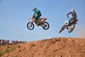 Two participants motocross are flying across over the hill Royalty Free Stock Photo