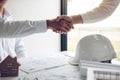 Two partnership engineering man with construction worker greeting shaking hand a foreman at renovating apartment Royalty Free Stock Photo