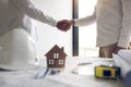 Two partnership engineering man with construction worker greeting shaking hand a foreman at renovating apartment Royalty Free Stock Photo