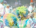 Two partpicients wearing large wigs and covered with blue and gr