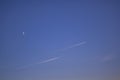 Two passenger planes passing parallel in the blue sky. Traces made by aircraft Royalty Free Stock Photo