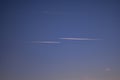 Two passenger planes passing parallel in the blue sky. Traces made by aircraft Royalty Free Stock Photo