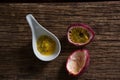 Two passion fruit and spoon with passion fruit pulp on wooden table Royalty Free Stock Photo