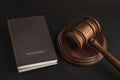 Two passports and judge gavel. Gray black background. Legal immigration. Obtain citizenship