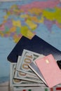 Two passports, one hundred dollar bills and bank cards. Against the background of a world map. Silhouettes of continents are Royalty Free Stock Photo