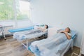 Two patient women lie on bed in ward medical hospital. Chemotherapy tretment concept Royalty Free Stock Photo