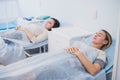 Two patient women lie on bed in ward medical hospital. Chemotherapy tretment concept Royalty Free Stock Photo